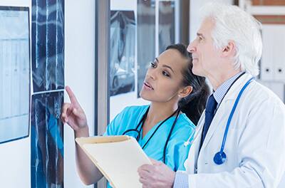 Nurse and Docutor going over xray sheet